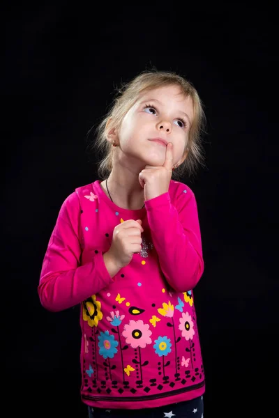 Emotie concept: dromerige schattig meisje. Zwarte achtergrond, studio foto. — Stockfoto