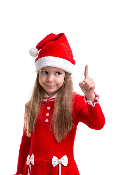 Chica de Navidad difícil con un dedo apuntando hacia arriba, con un sombrero de santa aislado sobre un fondo blanco, primer plano —  Fotos de Stock