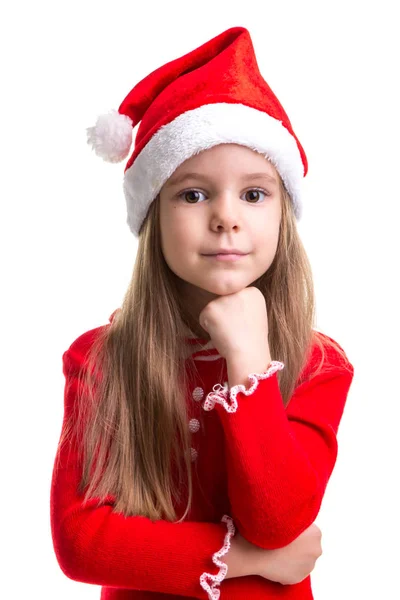 Atractiva chica de Navidad sonriente con un puño debajo de la barbilla, con un sombrero de santa aislado sobre un fondo blanco —  Fotos de Stock