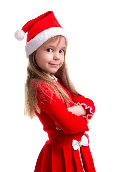 Sorrindo coquete menina de Natal vestindo um chapéu de Papai Noel isolado sobre um fundo branco, de pé na meia volta. Imagem do retrato — Fotografia de Stock