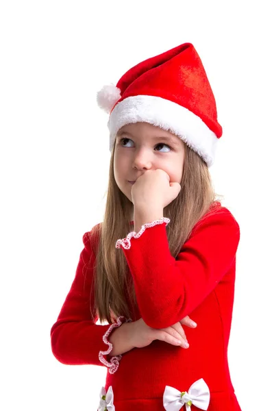 Chica de Navidad seria con el puño debajo de la barbilla, mirando hacia arriba, con un sombrero de santa aislado sobre un fondo blanco —  Fotos de Stock