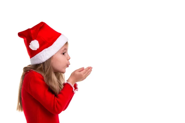 Esperando un milagro. Vista del perfil de una chica de Navidad cogida de la mano y soplando sobre ellos en el fondo blanco aislado. Chica de pie a la izquierda, gran imagen de la creación —  Fotos de Stock