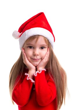 Doğrudan kameraya bakarak onun elele çene altında beyaz bir arka plan üzerinde izole Noel Baba şapkası giyen mutlu cilveli Noel kız. Portre resim