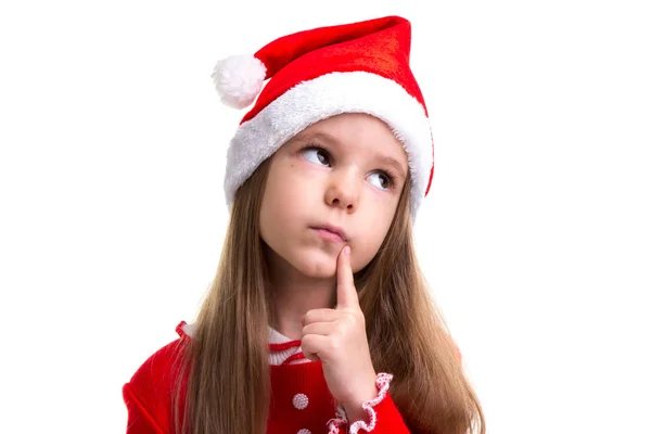 Closeup sonhadora menina natal vestindo um chapéu de Papai Noel isolado sobre um fundo branco — Fotografia de Stock