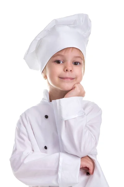 微笑的女孩厨师白色制服隔离在白色背景上, 直视镜头, 握着下巴下的手。人像图像 免版税图库照片