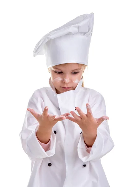 Menina chef uniforme branco isolado no fundo branco. Olhando de olhos abertos para as palmas das mãos. Cara farinhada. Imagem do retrato — Fotografia de Stock