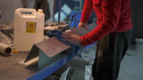 Les travailleurs essuient à la main le produit métallique avec un chiffon avec un dégraissant — Video