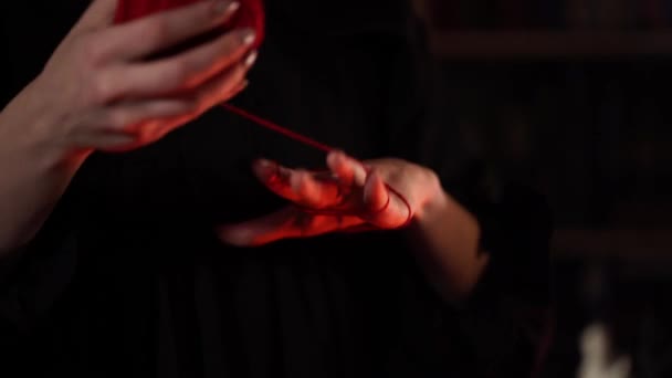 Session of black magic with a red thread — Stock Video