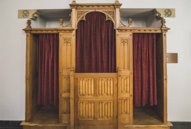 wooden room for confession in the church clipart