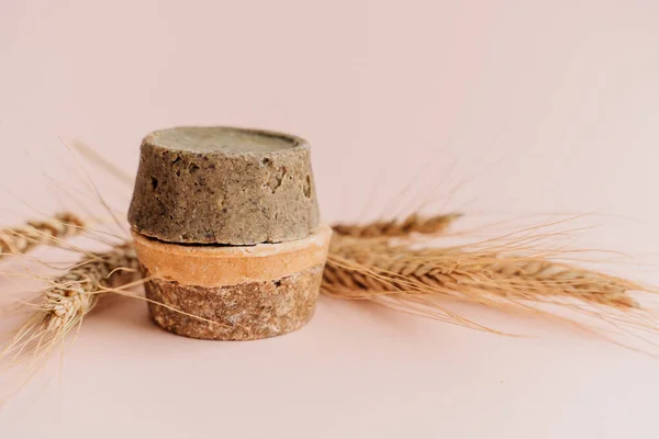 hand-made solid dry shampoos of a round shape on a plain beige background. natural hair cosmetics. soap for handicraft from chamomile and eucalyptus. environmentally friendly products, no waste