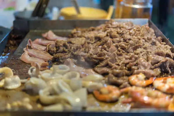 stock image Grilled raw meat beef and pork (barbeque, bbq) a food cooking on wagyu grill in BBQ. yakiniku grill buffet restaurant