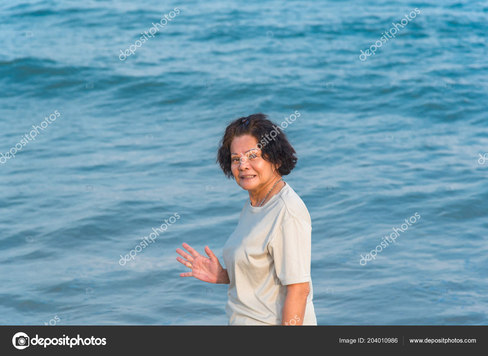 Asian Elderly Woman 60s Curly Hair Happy Travel Relax Sea Stock