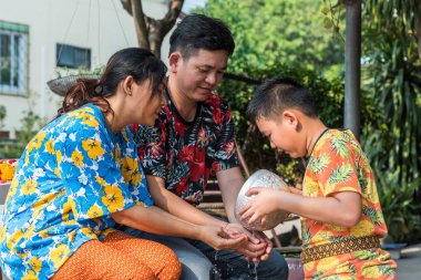 Ang Thong, Tayland - 13 Nisan 2018: Veliler tarafından su ile ilgili olarak kimliği belirsiz Asyalı Genç yıkanmak var bir yasemin ve gül çiçek ve oksijenli su su kase Songkran Festivali