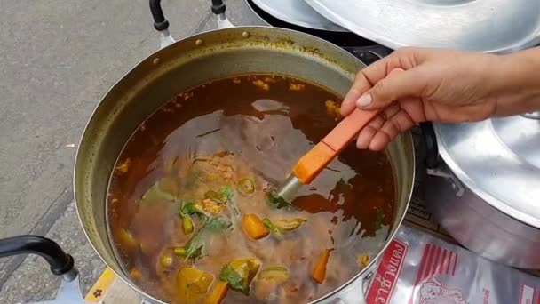 Slow motion of Hot spicy curry meat with Thai chili and herb and coconut milk for sale at Thai street food market or restaurant in Thailand — Stock Footage Slow Motion Hot Spicy Curry Meat Thai Chili Herb Coconut Royalty Free Stock Footage