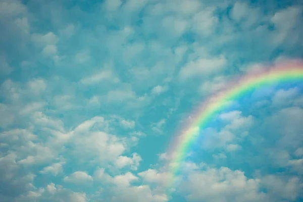 Cloudscape rainbow of natural sky with blue sky and white clouds and colorful rainbow in the sky use for wallpaper background, Process in vintage style