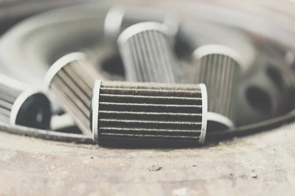 Old lubricant engine oil filter at car garage