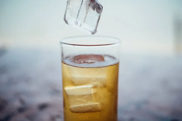 Fresh beer water in to glass with ice and froth — Stock Photo, Image