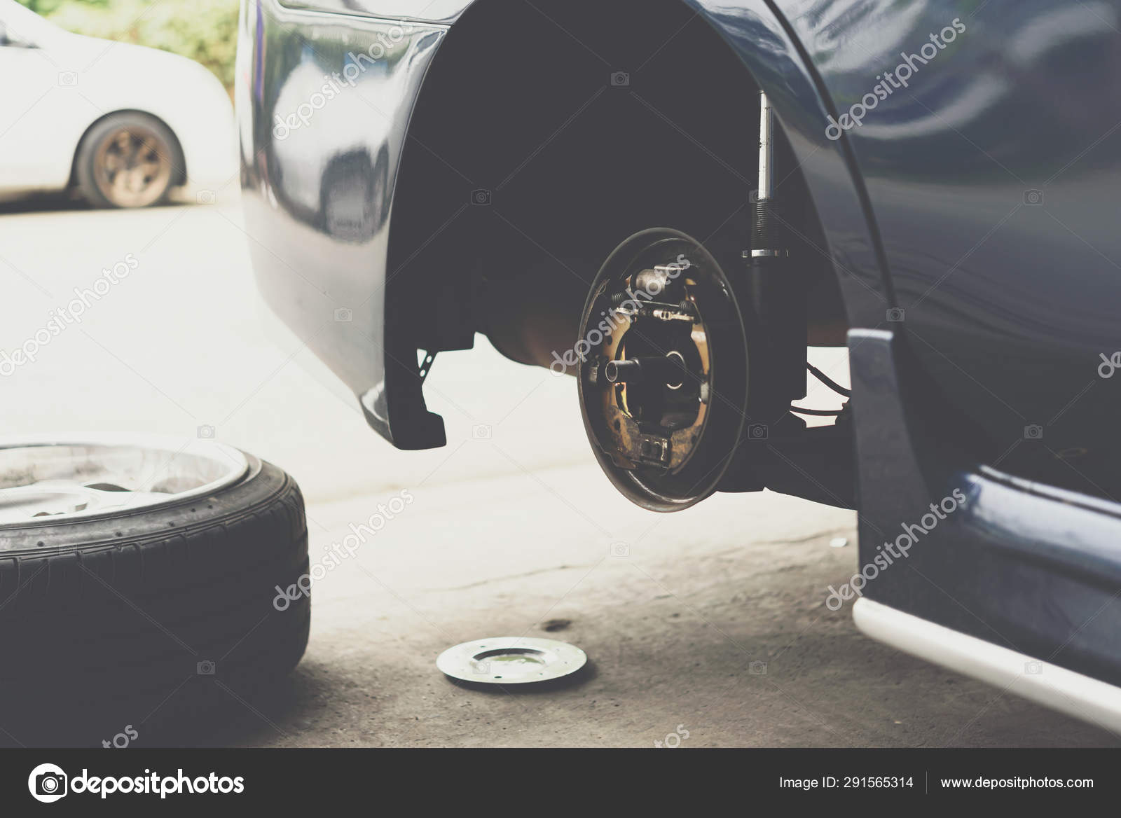 Drum Brake And Asbestos Brake Pads At Car Garage Stock Photo