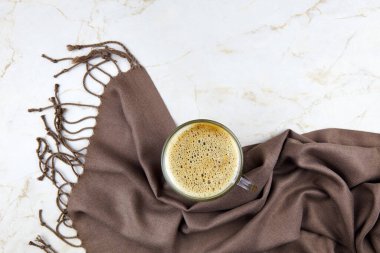 Hafif arka planda bir fincan kahve ve ekose. Sonbahar kompozisyonu. Düz yatış, üst görünüm