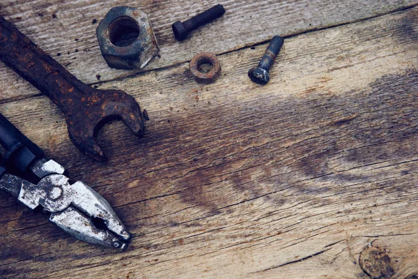 rusty old tools on old wooden boards