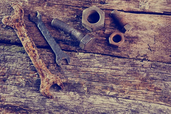 rusty old tools on old wooden boards