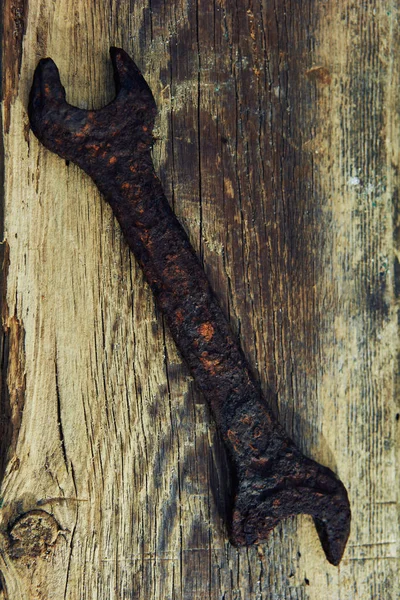 rusty old tools on old wooden boards