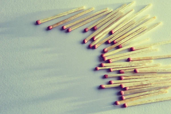 burned matches on a white background, a bunch of matches. and long shadows