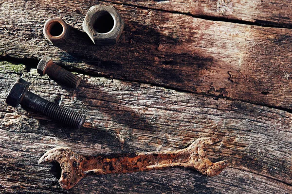 rusty old tools on old wooden boards