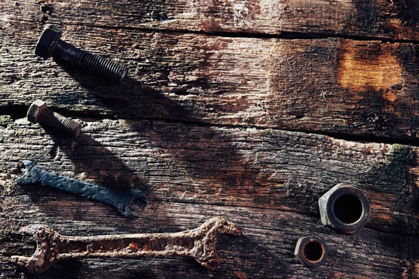rusty old tools on old wooden boards