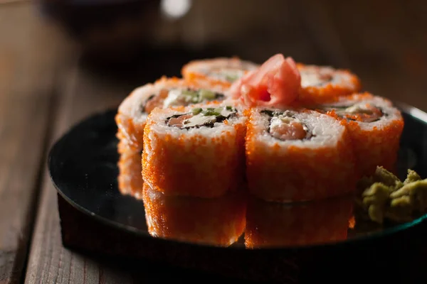 Small set of rolled sushi with red caviar and cucumber