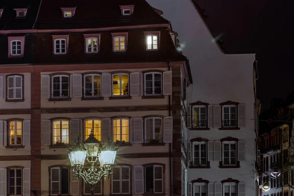 Street lamp and buildings with highlighted windows, night view of Strasbourg, France