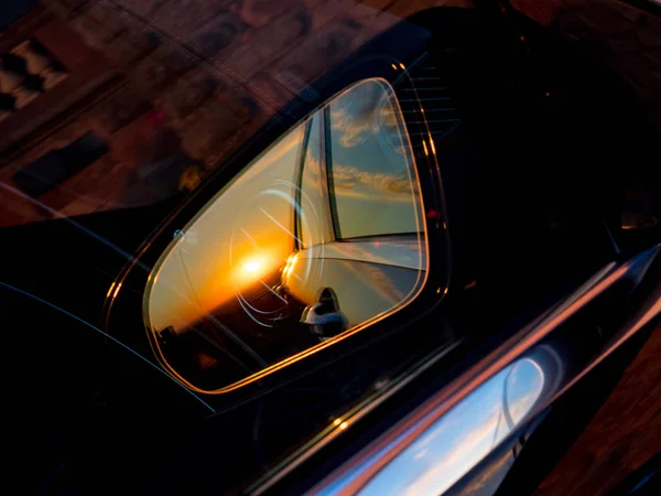 Luxury car mirror with sunset reflection — Stock Photo, Image