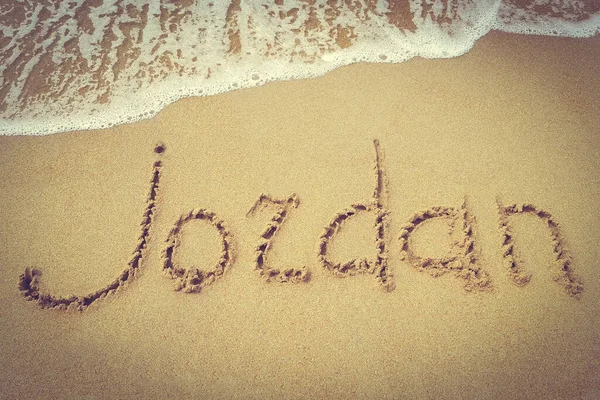 Jordan title on the sand beach of the coast Red sea. Surf. The vignette in the photo.