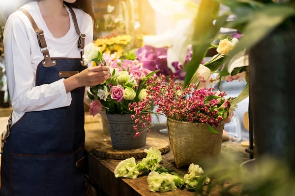 young women business owner florist making bouquet  in front of flower shop