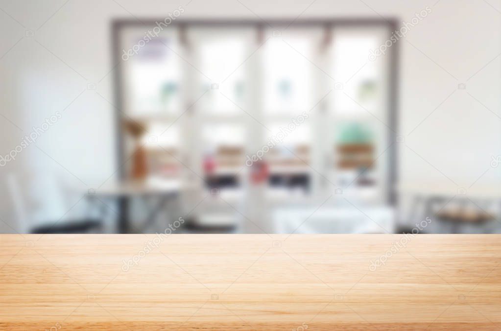 Selected focus empty brown wooden table and Coffee shop blur background with bokeh image. for your photomontage or product display.