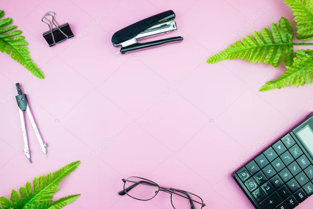 Office table desk with business computer, green leaves palm, clipboard feminine tabletop. flat lay image of workplace and copy space