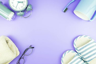 madeni eşya saat düz yatıyordu kompozisyon diş fırçası gözlük, mavi ve mor menekşe kavramı üzerinde havlu ve terlik üstten görünüm