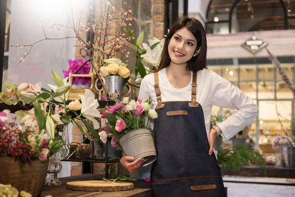 young women business owner florist making bouquet  in front of flower shop