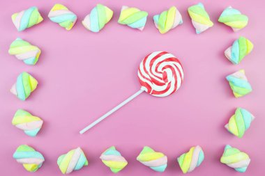 Üstten görünüm lezzetli iştah açıcı kavramı, en az tatlı tedavi girdap Candy lolipop hatmi renkli desen pembe pastel zemin üzerine yat ve uzay kopyalayın