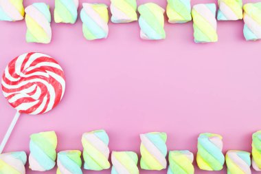 Üstten görünüm lezzetli iştah açıcı kavramı, en az tatlı tedavi girdap Candy lolipop hatmi renkli desen pembe pastel zemin üzerine yat ve uzay kopyalayın