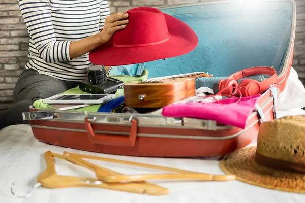 Woman hand packing a luggage for a new journey and travel for a long weekend