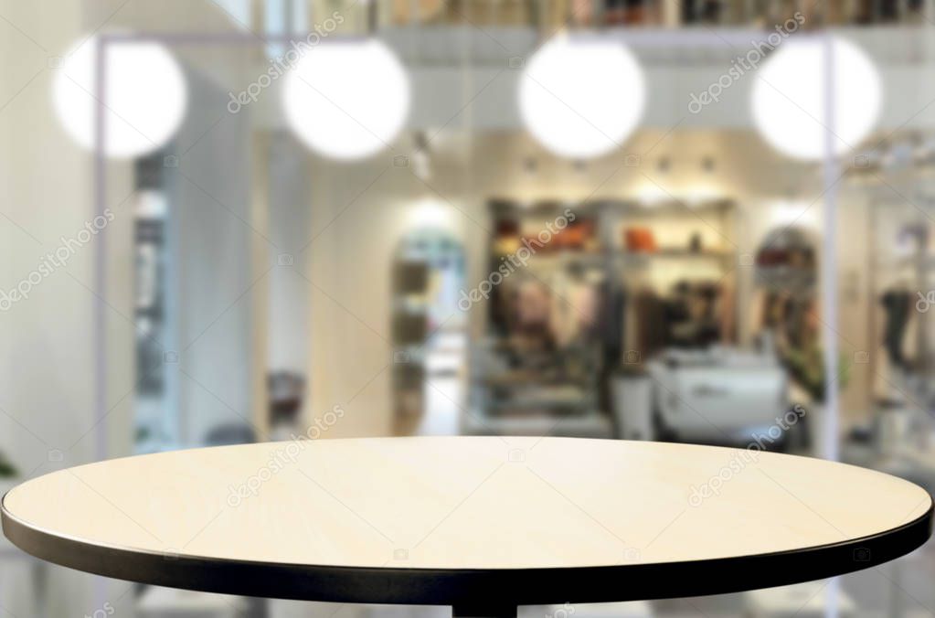 Selected focus empty brown wooden table and Coffee shop or restaurant blur background with bokeh image. for your photomontage or product display.