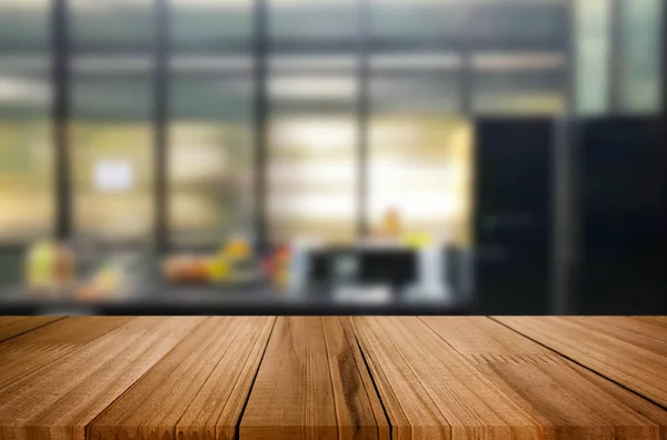 Wood table top on blur kitchen or cafe room background .For montage product display design key visual layout.