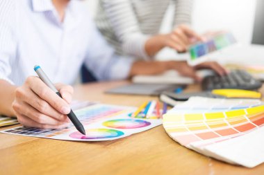 tasarımcı grafik yaratıcı yaratıcılık birlikte meslektaşı ile masada grafik tablet ve kalem kullanarak boyama çalışma 