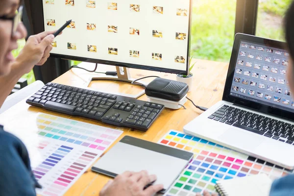 Tablet ve kalem, içinde meşgul yaratıcı bürolar kullanarak resmi düzenleme renk örneklerini kullanarak web tasarım grafik tasarımcı ekibi