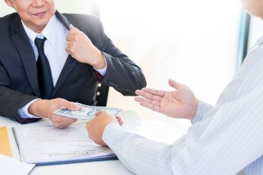 İşadamı ya da rüşvet ve para ile el sallayarak takım elbiseli, yolsuzluk ticaret Döviz kavramı alarak politikacı