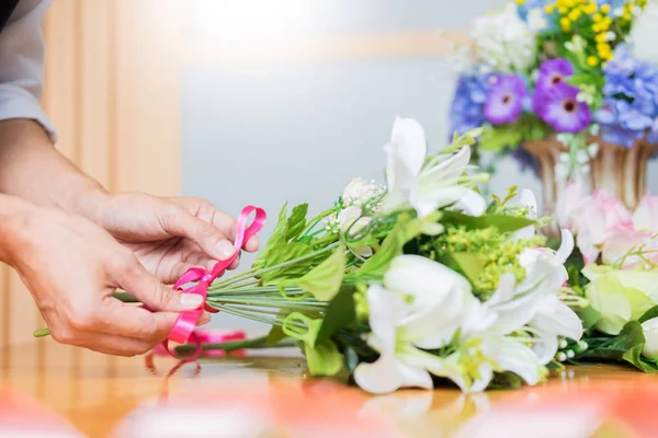Жіночий флорист на роботі, використовуючи аранжування, роблячи красивий штучний — стокове фото