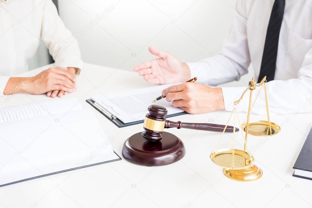 business people and lawyers discussing contract papers sitting a