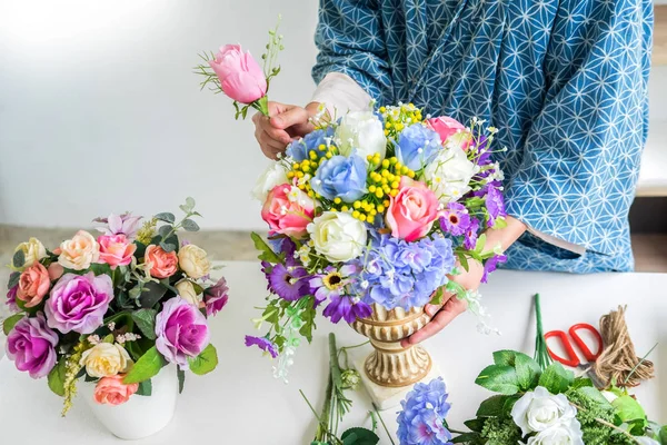 Giovani donne imprenditore fiorista fare o organizzare fiori artificiali gilet nel suo negozio, artigianato e concetto fatto a mano . — Foto Stock