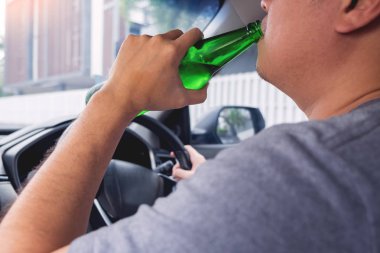 Sürücü konsepti için içme, Genç Sarhoş adam içme şişesi o